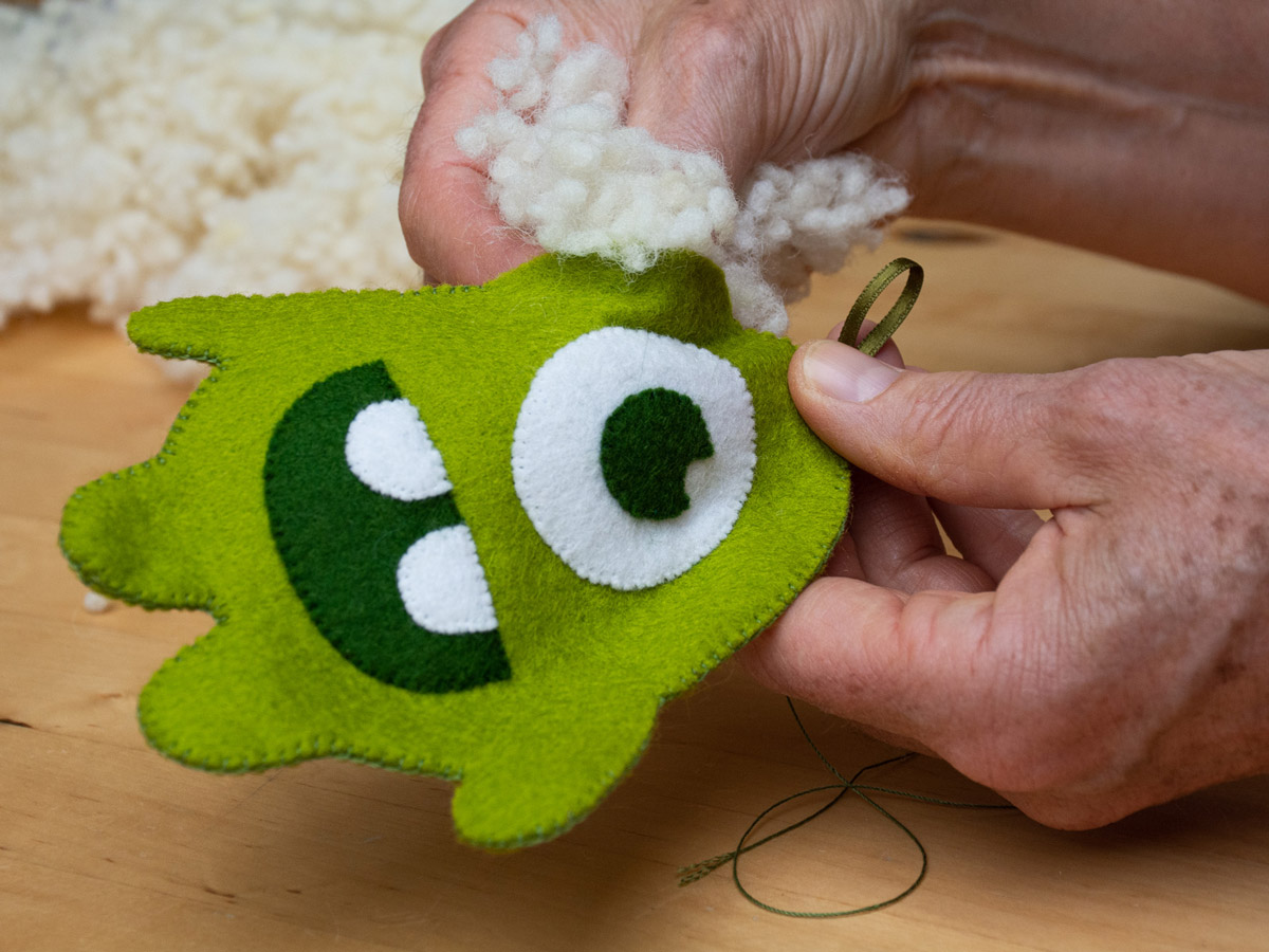 Image of a Happy Monster Club cuddly toy that is filled with pure wool